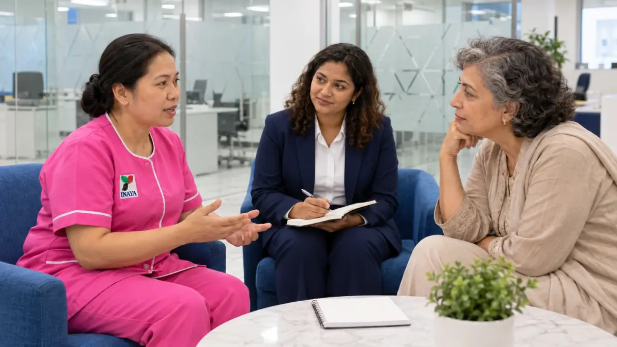 Couple interviewing a domestic worker in a living room.
