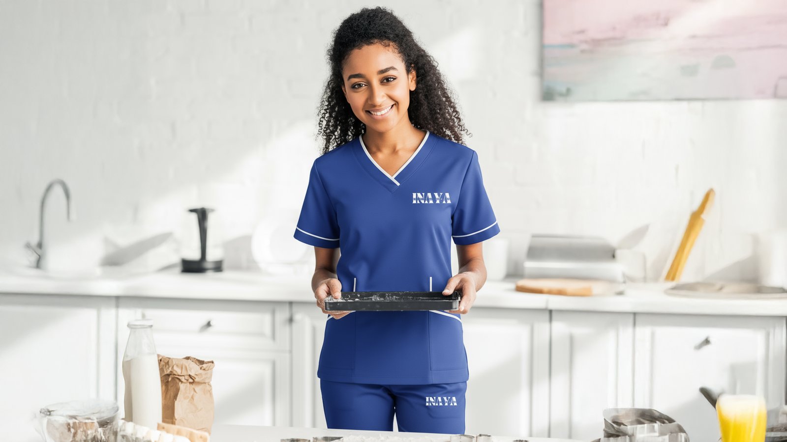 INAYA uniform with a baking tray