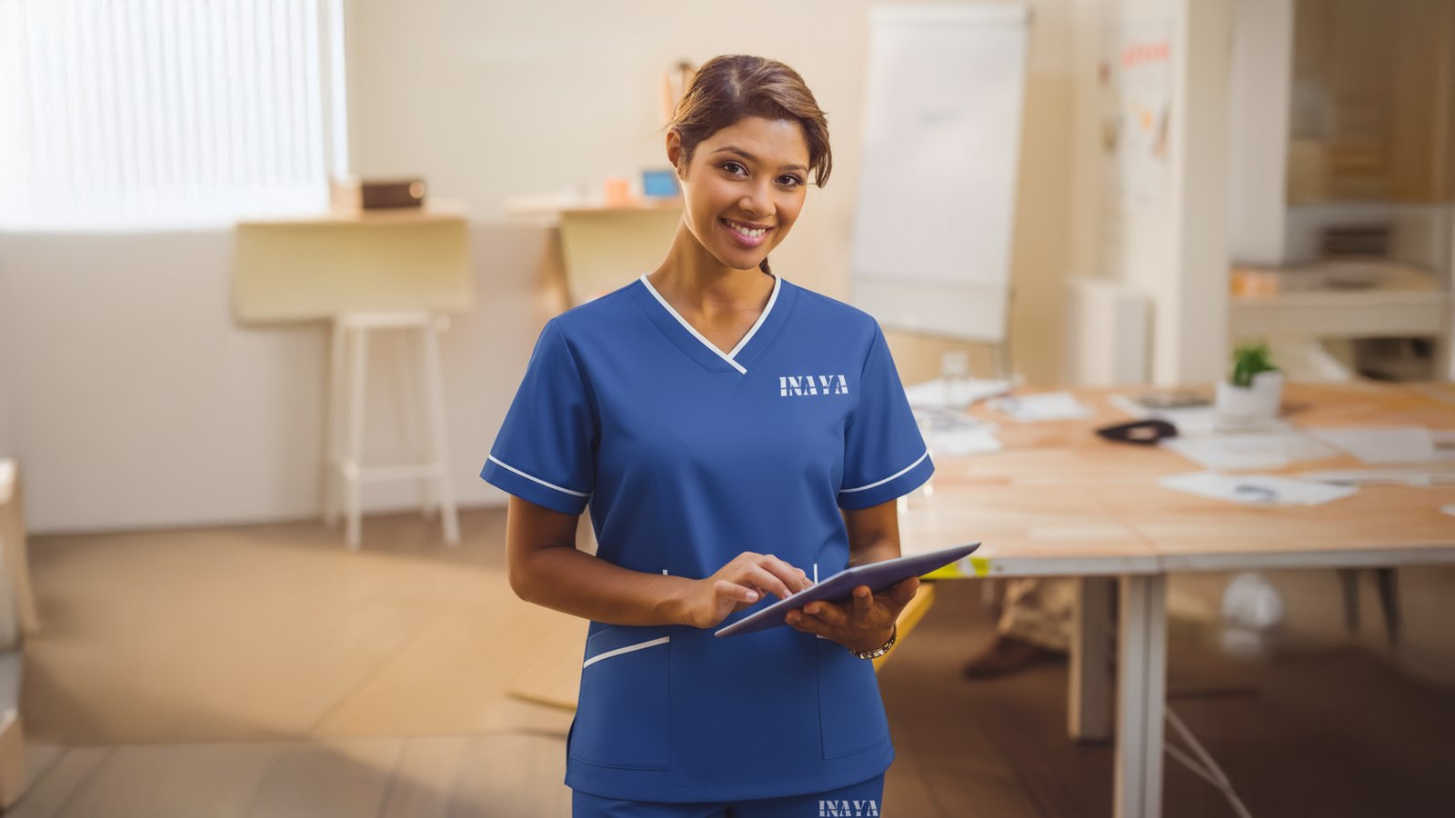 INAYA uniform with a tablet