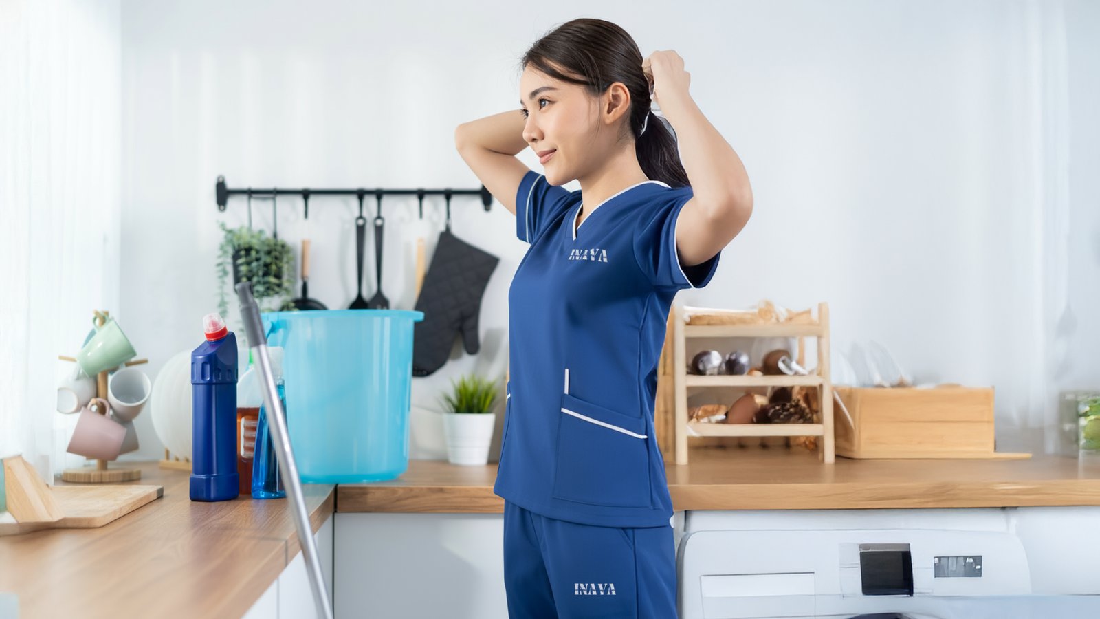 INAYA uniform beside household cleaning supplies