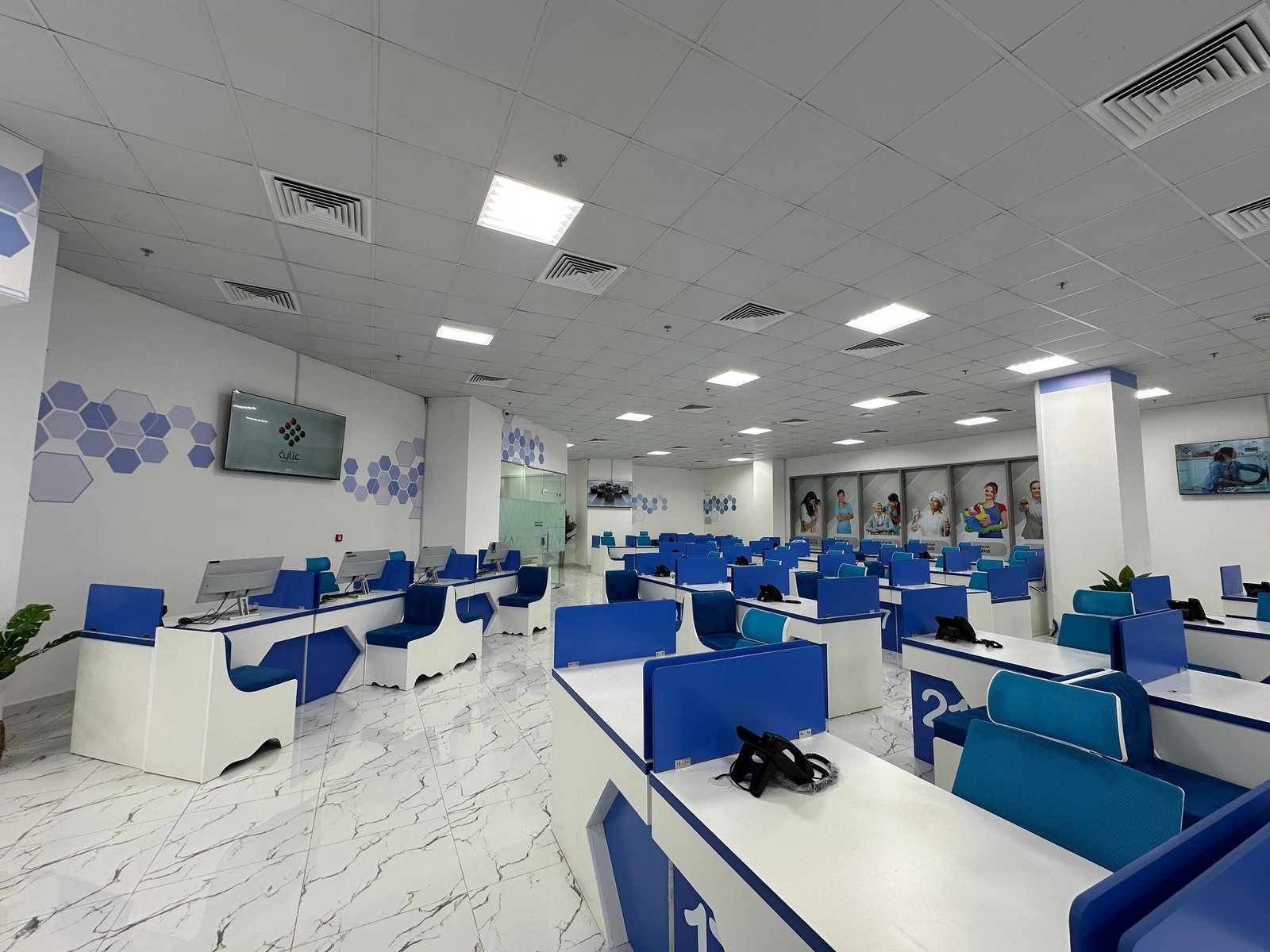 INAYA Ajman customer-service hall and numbered counters