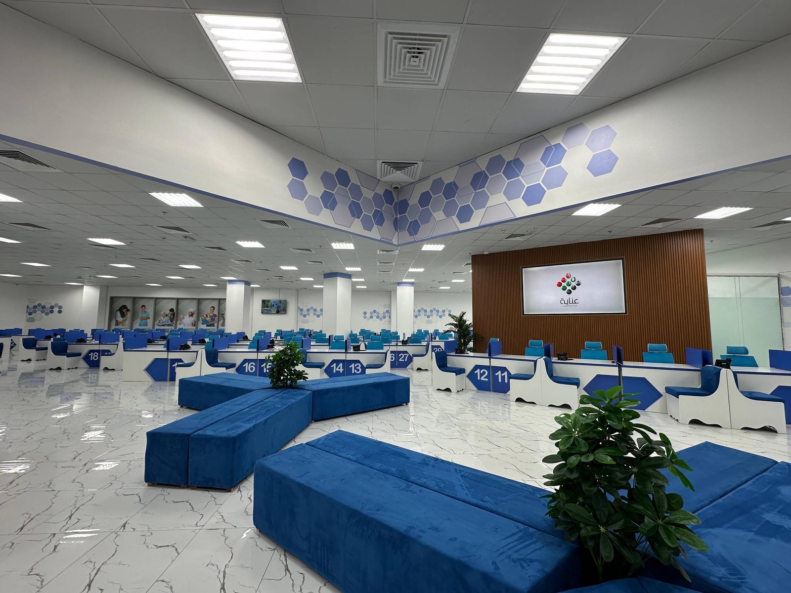 Blue waiting benches and counters inside INAYA Ajman