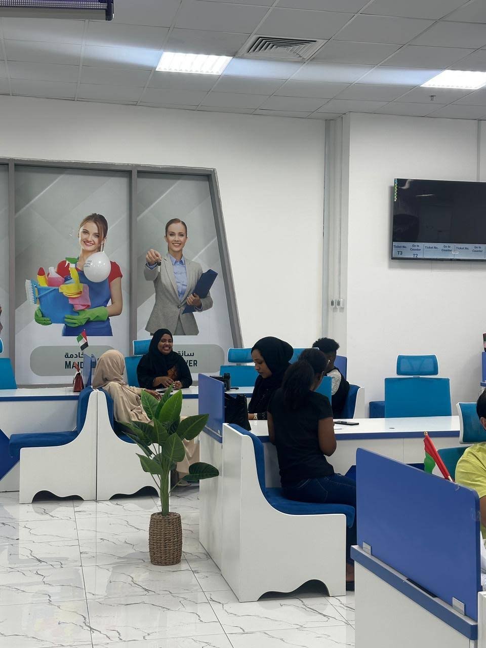 Customer seating beside INAYA Ajman service counters