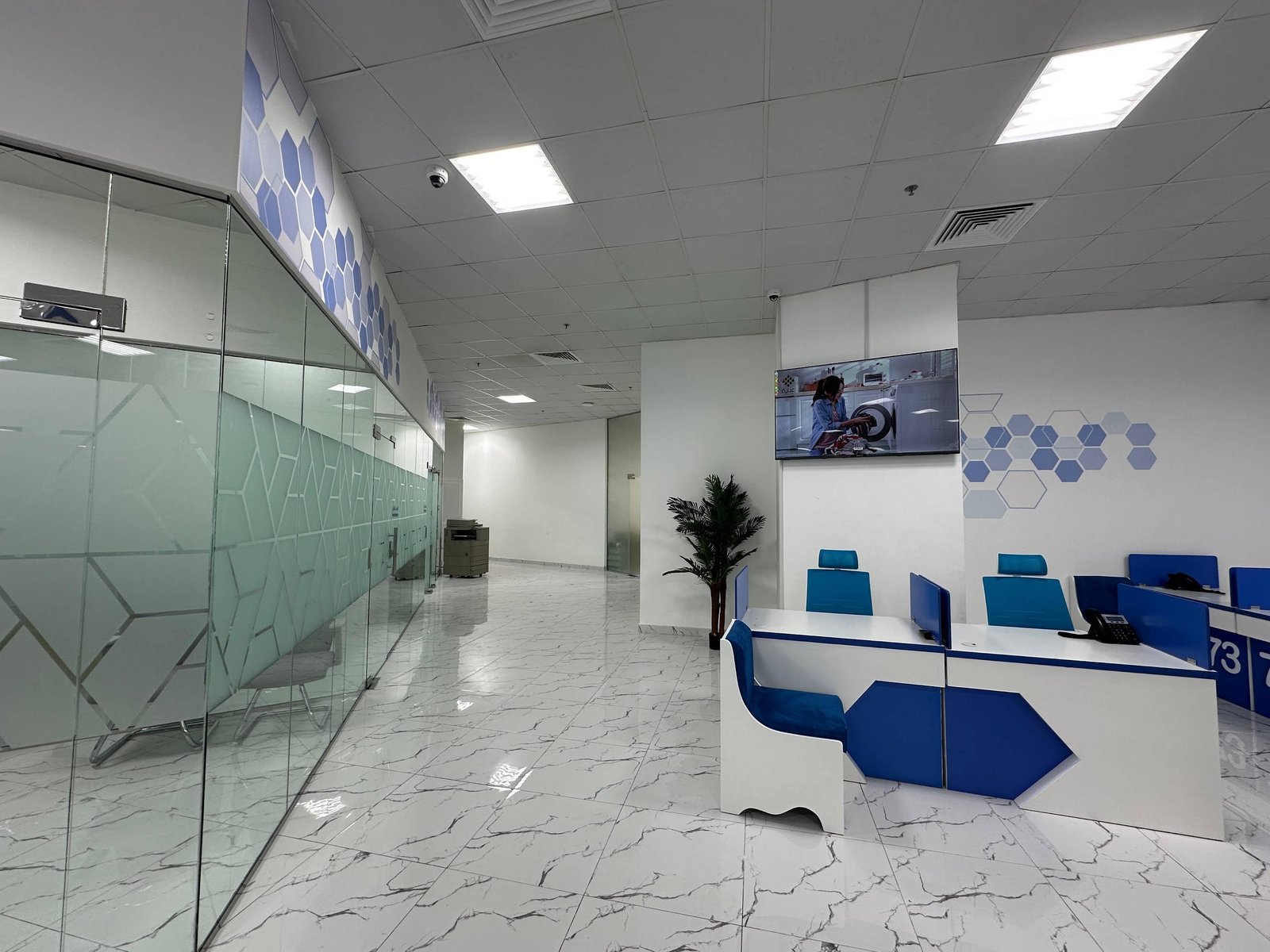INAYA Ajman glass office partitions and numbered counters