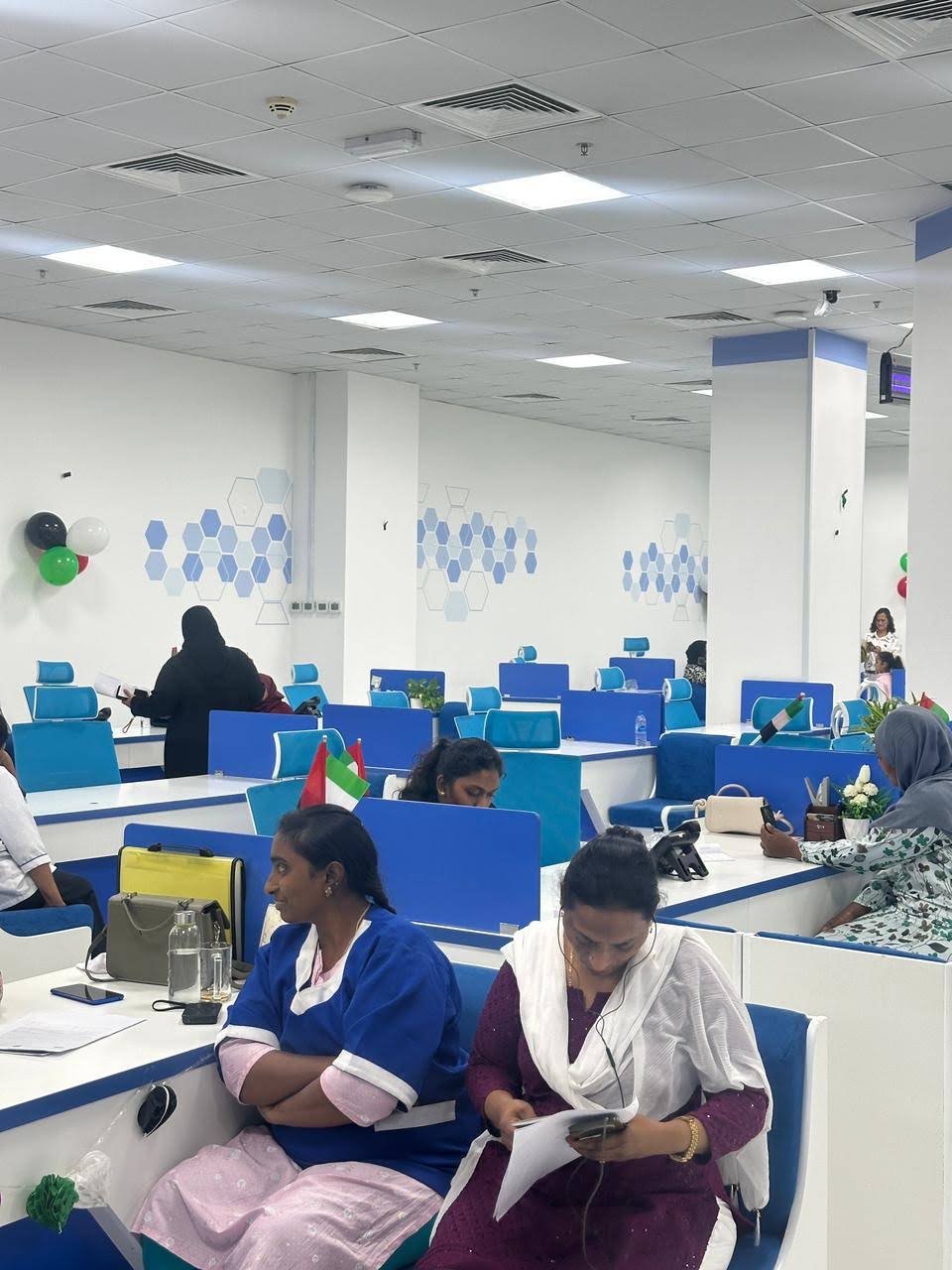 Visitors seated beside INAYA Ajman service counters