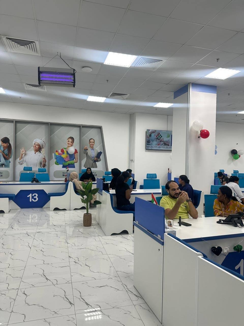 INAYA Ajman service counters and waiting visitors