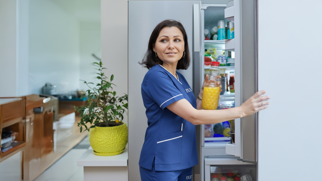 Maid standing near window while organizing and cleaning home