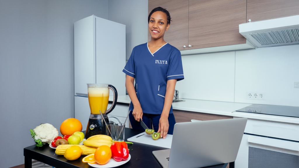 Professional maid preparing fresh juice in a clean kitchen in Ajman