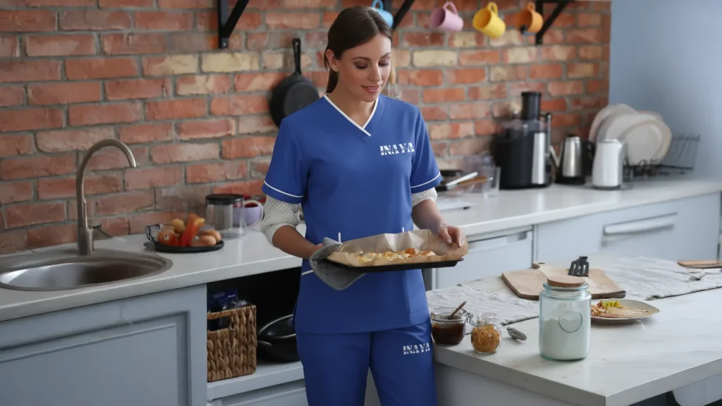 Maid from INAYA Ajman folding family laundry