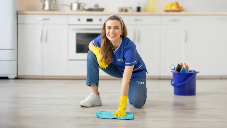 Maid sweeping hallway floor